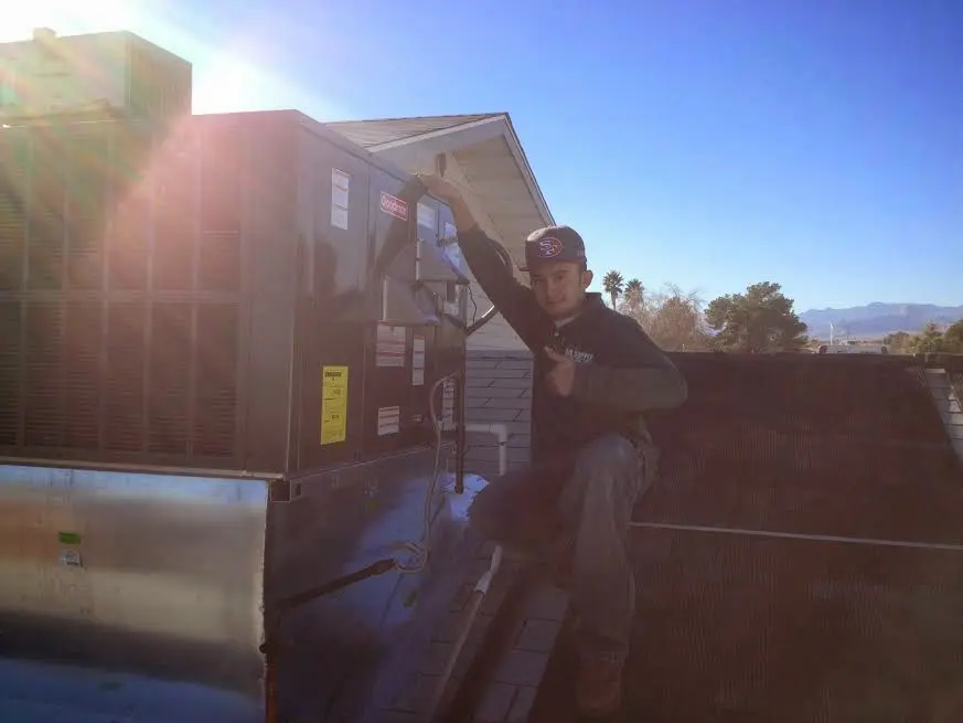 HVAC technician performing Air Duct Repair on a rooftop unit in Medical Lake